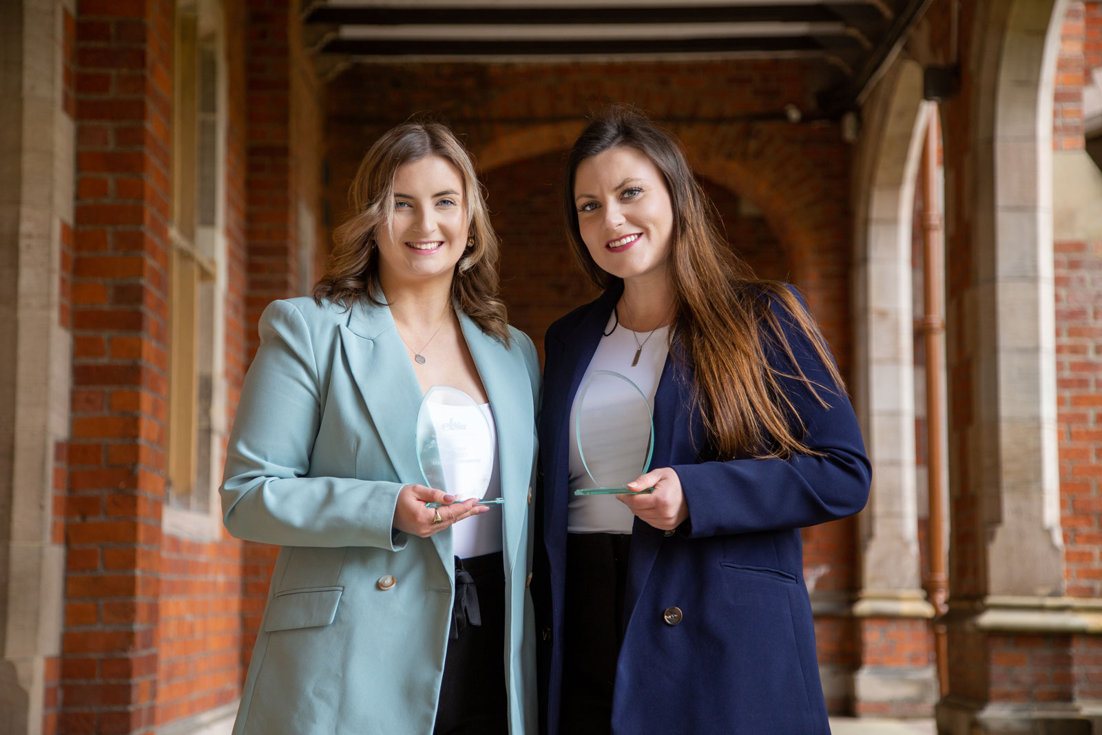 image of Ciara and Jessica with their trophies under the portico in the Quad