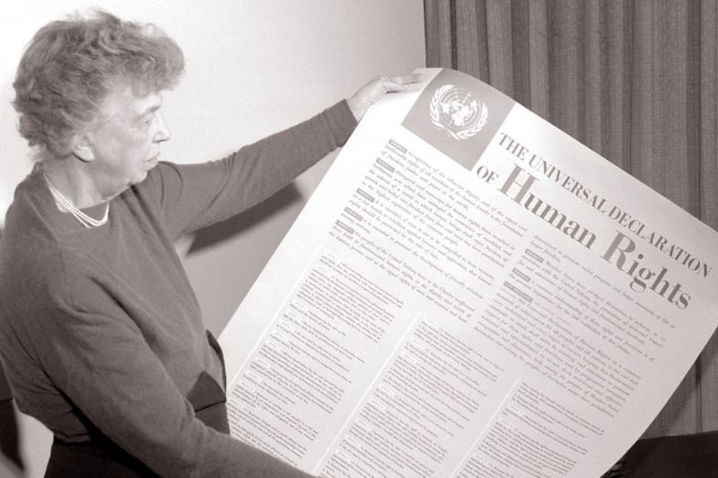 Woman holding the Declaration of Human Rights